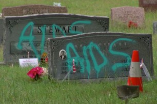 The vandalized headstones at the Evergreen Cemetery in Austin, Texas.