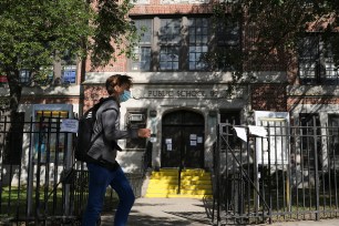 A child walks past PS 20, a school closed in the Kew Gardens COVID-19 hot spot.