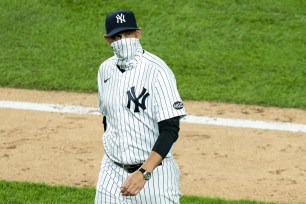 New York Yankees manager Aaron Boone wears a neck gaiter during a game against the Boston Red Sox at Yankee Stadium on August 14.