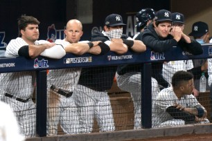 Yankees players wear dejected expressions in the dugout during their 8-4 Game 3 loss to the Rays.