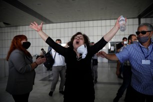 Magda Fyssa, the mother of late Greek rap singer Pavlos Fyssas, who was stabbed and killed by a supporter of the extreme right Golden Dawn party in 2013 triggering a crackdown on the party, celebrates after the announcement of a court decision in Athens.