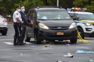 Officials at the scene of the fatal accident in Queens today.