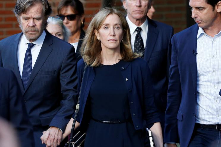 Felicity Huffman leaves the federal courthouse with her husband William H. Macy after being sentenced in the college admissions scandal last year.