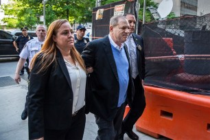 Sgt. Keri Thompson escorts a handcuffed Harvey Weinstein to the Supreme Court in Manhattan in 2018.
