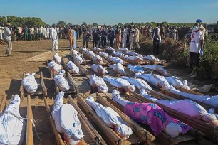 Nigerians attend a mass burial of farm workers killed in an attack at Zabarmari