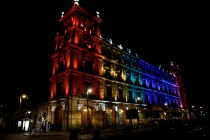 The colors of the Pride rainbow flag symbolizing gay rights, are projected on a building, after a Gay Pride Parade, in downtown Mexico City, Mexico.