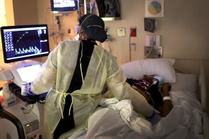 A member of the medical staff performs an echocardiogram on a COVID-19 patient at Roseland Community Hospital in Chicago, Illinois.