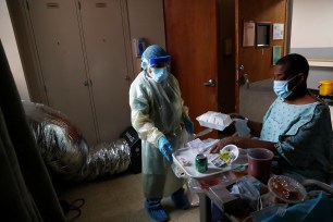 Evelia cleans for coronavirus patient Bruce Shackleford in his isolation room