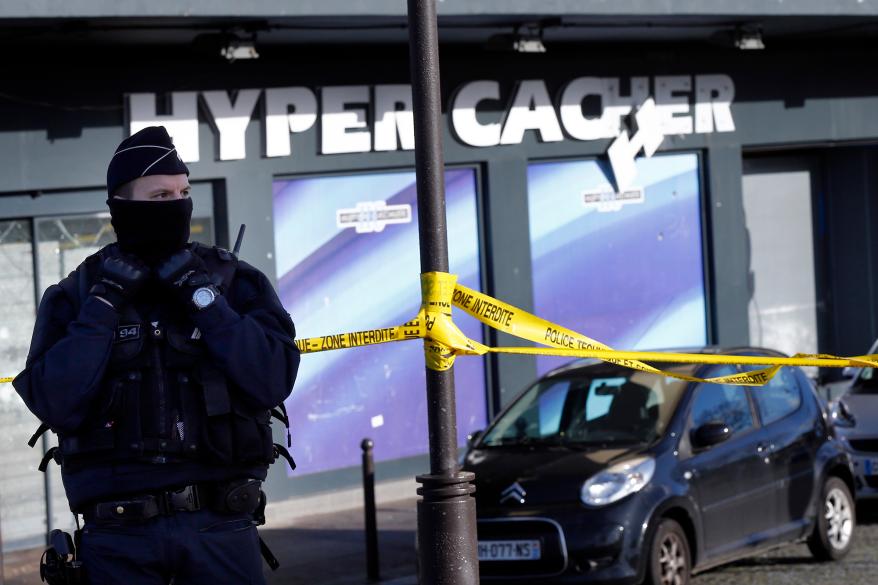 French police officers guards outside the Hyper Cacher supermarket in Paris, France.