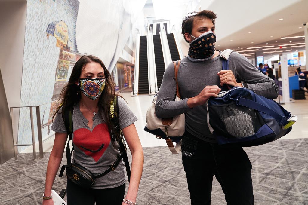 Passengers Daniel Weiss (right) and Justine Laufer arrive at LaGuardia Airport today.