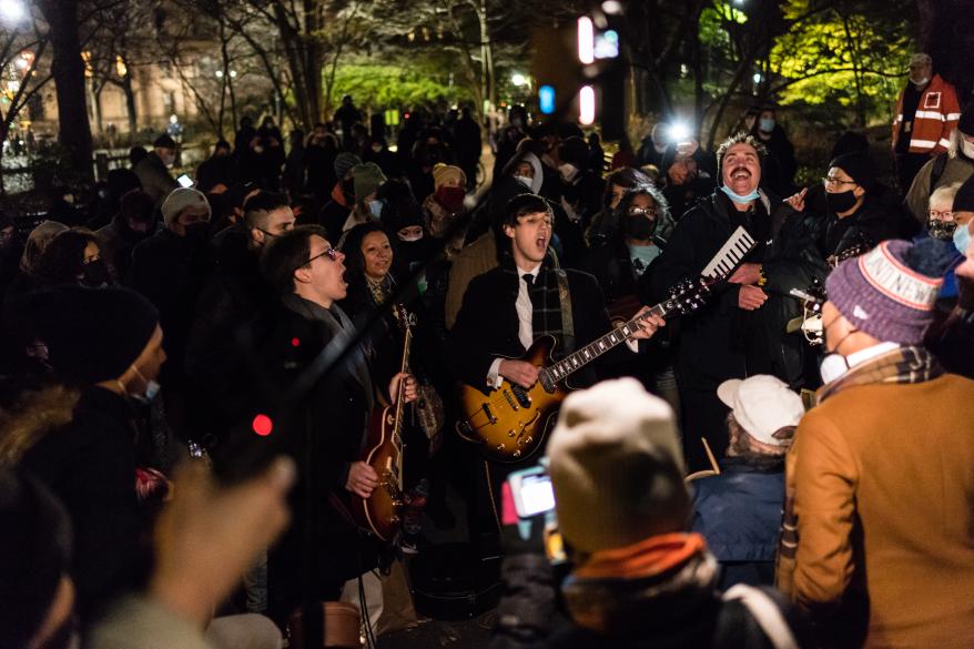 Fans singing at the memorial to John Lennon.