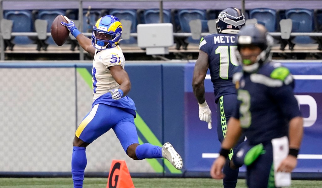 Darious Williams celebrates after his pick-six interception on Russell Wilson during the Rams' 30-20 NFC wild-card win over the Seahawks.