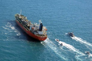 A handout photo made available by the Tasnim News agency shows Iranian Revolutionary Guard Corps (IRGC)' jet boats seizing a South-Korean flagged tanker named Hankuk Chemi in the Persian Gulf