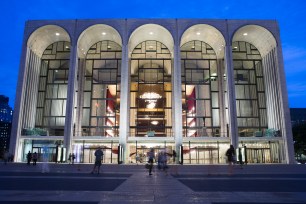 FILE - In this Aug. 1, 2014, file photo, pedestrians make their way in front of the Metropolitan Opera