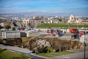 A view of the large sinkhole that opened overnight in the parking lot of Ospedale del Mare hospital in Naples, Italy.