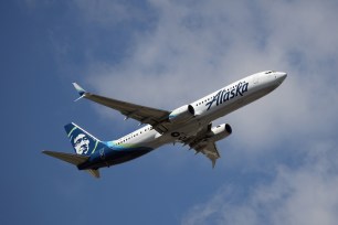 A Boeing 737-990 (ER) operated by Alaska Airlines takes off.