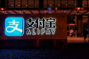 An Alipay logo is seen next to the Shanghai office building of its parent company, the Ant Group.