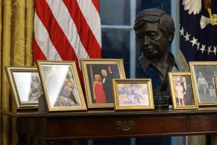 Behind President Biden’s presidential desk lies framed family photos.