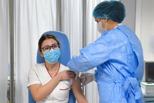 A nurse gets the COVID-19 vaccine.