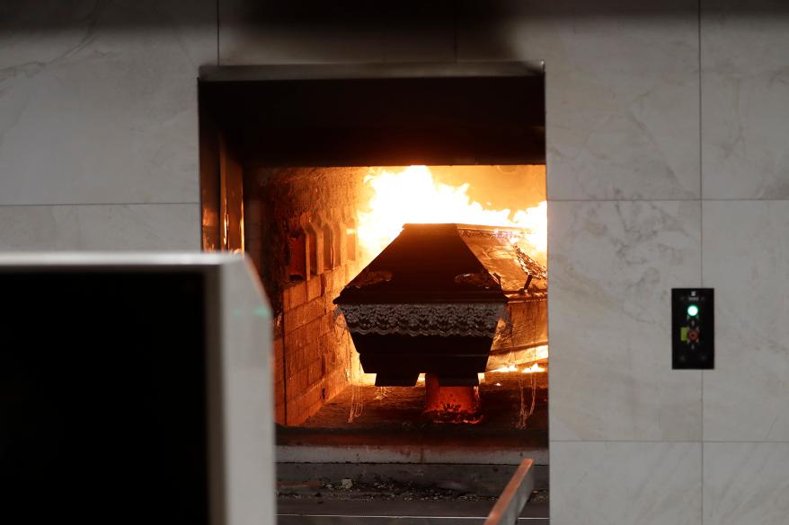 A casket is incinerated at a crematorium in Ostrava, Czech Republic, Thursday, Jan. 7, 2021.