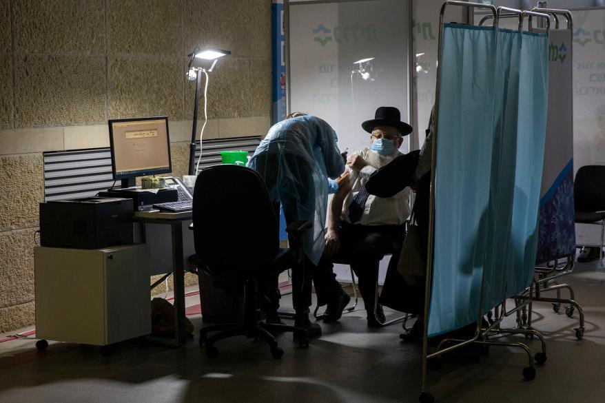 A man receives a Pfizer COVID-19 vaccine in Jerusalem.