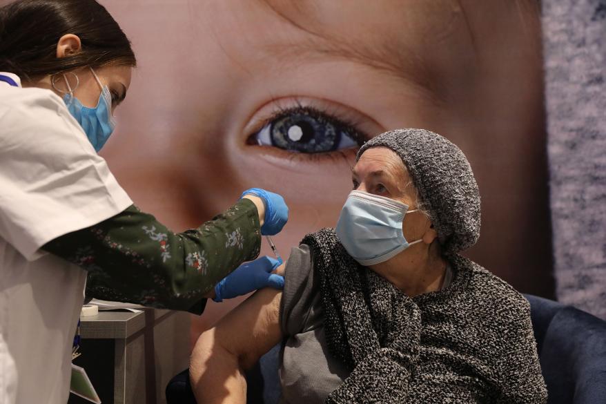 An Israeli woman receives a COVID-19 vaccine in Jerusalem.