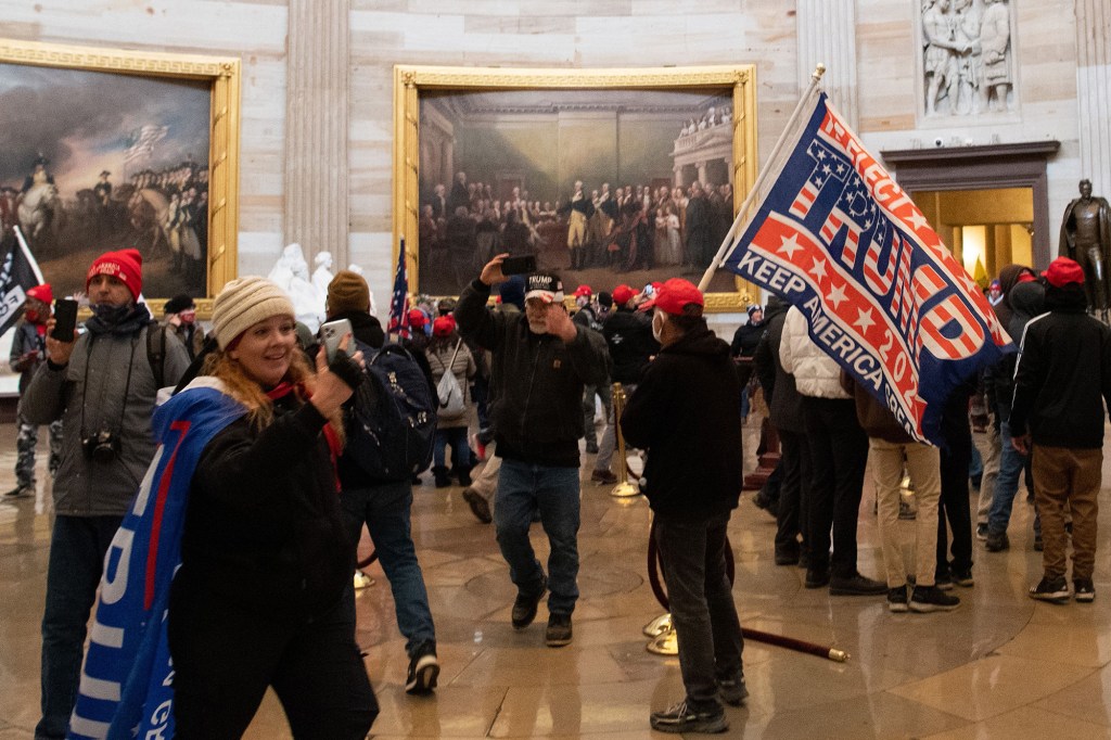 Trump supporter Jenny Cudd takes pictures in the Capitol Rotunda after breaching security to enter the building.