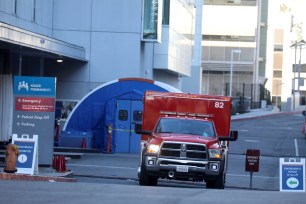 An ambulance crew leaves Kaiser Permanente Hospital emergency room during a surge of COVID-19 cases