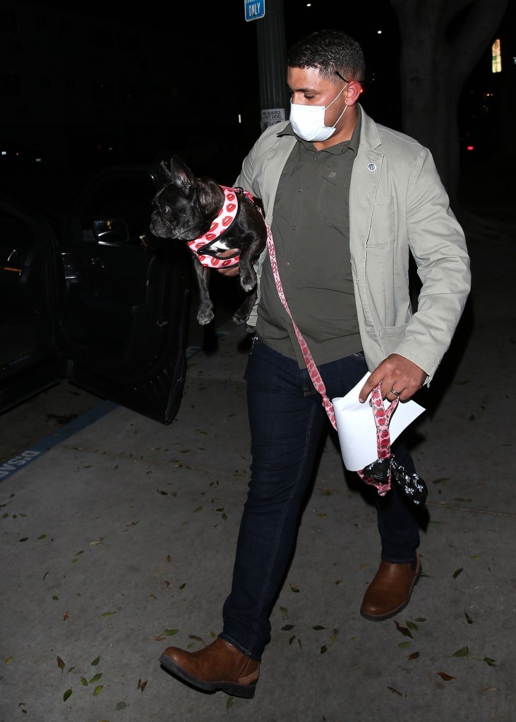Lady Gaga's dog is picked up by her bodyguard at the Hollywood LAPD station.