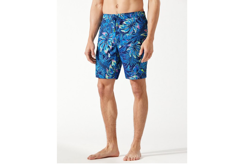 A man in blue leaf print swim trunks