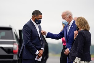 Rep. Cedric Richmond (left) and then-Democratic presidential nominee Joe Biden greet each other as Biden arrives at Columbus Airport