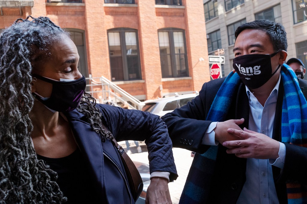 Democratic mayoral candidates Maya Wiley, left, and Andrew Yang bump elbows before holding a news conference on March 11, 2021.