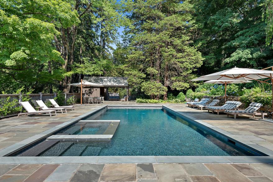 The grounds include a sleek-looking pool.