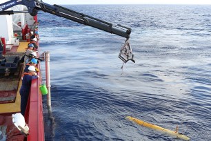 A Phoenix Autonomous Underwater Vehicle (AUV) Bluefin-21 is craned over the side of Australian Defence Vessel Ocean Shield in the search for missing Malaysia Airlines Flight MH370 on April 14, 2014.