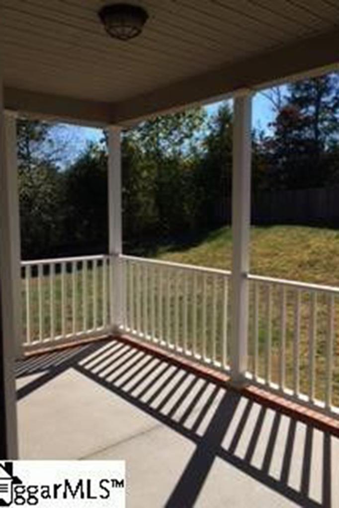 A covered back porch overlooks the half-acre lot at the end of a cul-de-sac.