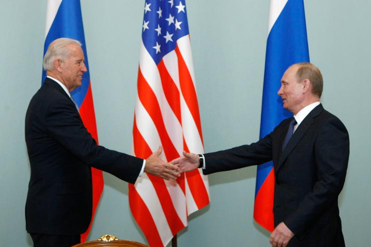 President Joe Biden, left, shakes hands with Vladimir Putin on March 10, 2011.