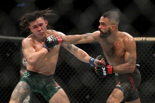 Rob Font (right) lands a punch on Ricky Simon.