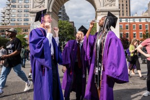 NYU students celebrate graduation in Washington Square Park fountain enjoying the sun on May 15, 2021.