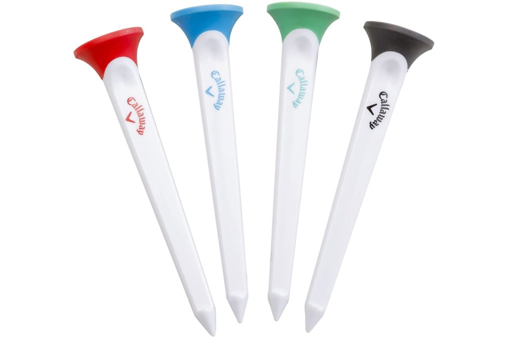 A set of four white golf tees with colored tops 