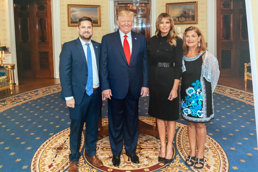 Brett Eagelson is seen with former President Donald Trump and former First Lady Melania Trump.