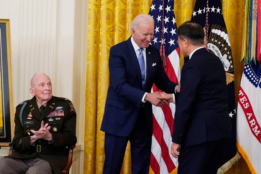 President Joe Biden greets South Korean President Moon Jae-in, as retired U.S. Army Col. Ralph Puckett looks on, during a Medal of Honor ceremony.