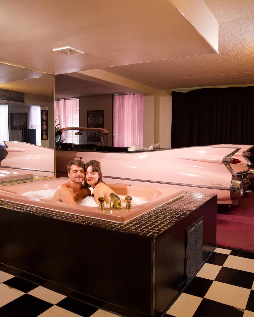 The Bienerts cuddle up in a pink jacuzzi at the Red Carpet Inn in Greenwood, Indiana.