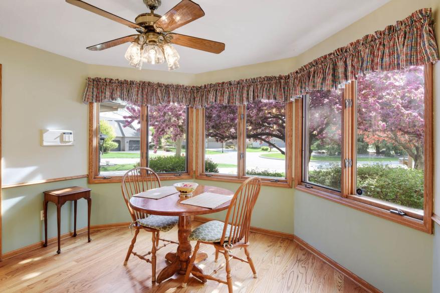 The five-sided breakfast nook extends from the kitchen on hardwood floors.