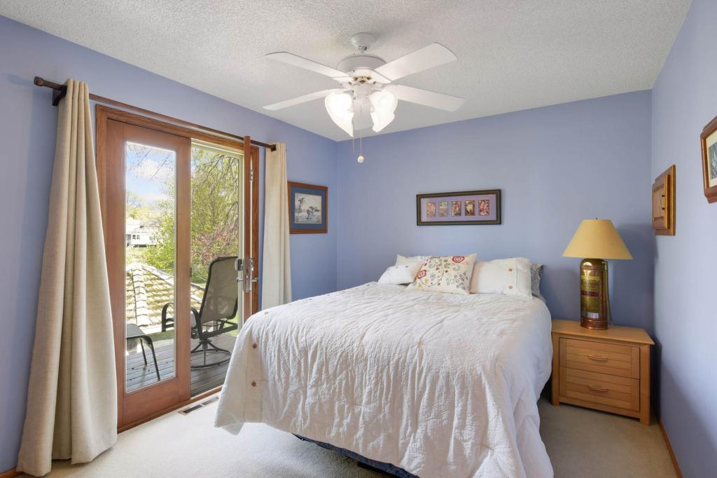 This blue bedroom has a balcony overlooking the back porch.