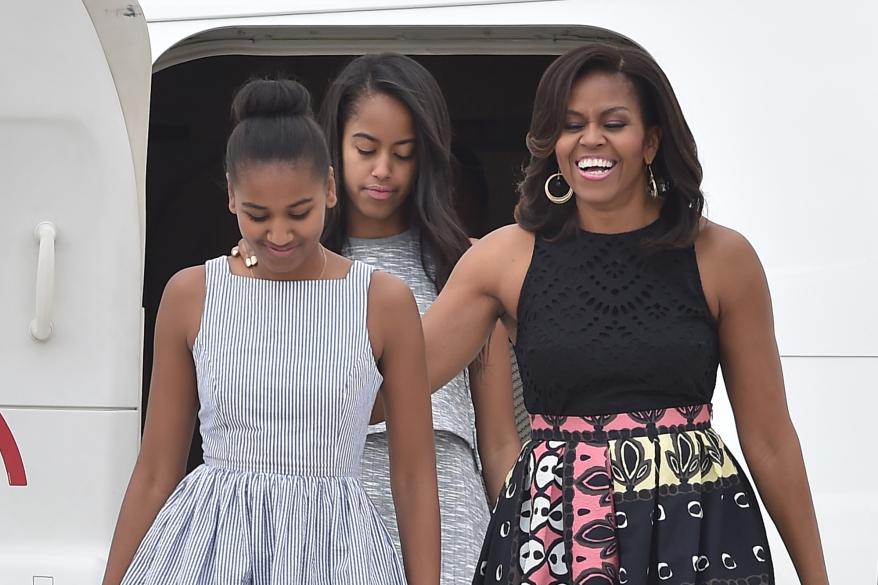 Former First Lady Michelle Obama said her daughters Malia (center) and Sasha (left) “are good students and polite girls.”