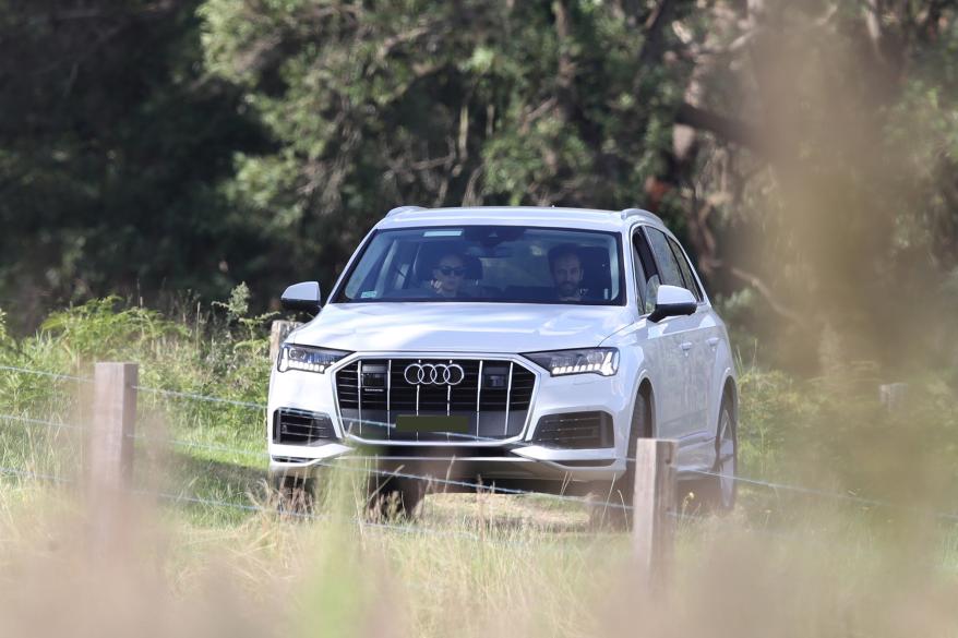 Their white Audi, which appears to be a model Q7.