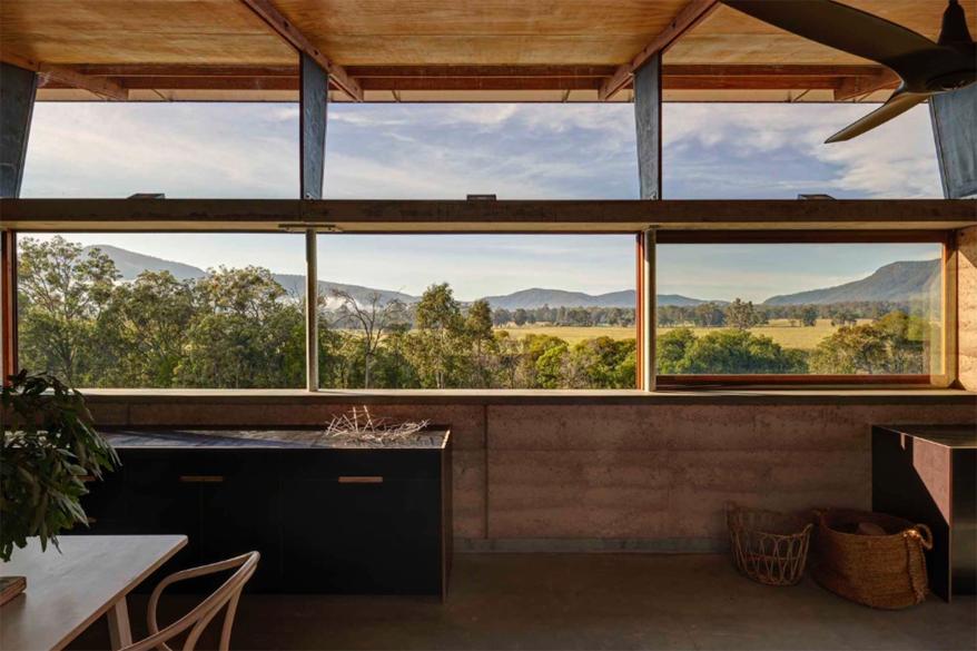 The kitchen has expansive windows.