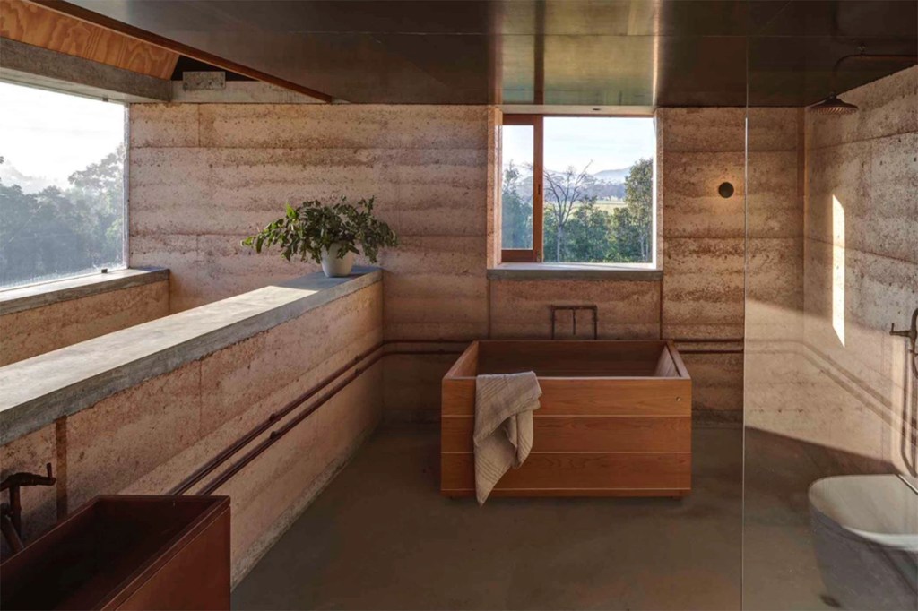 Natural tan-colored stone and wood is used to create this zen bathroom space. 
