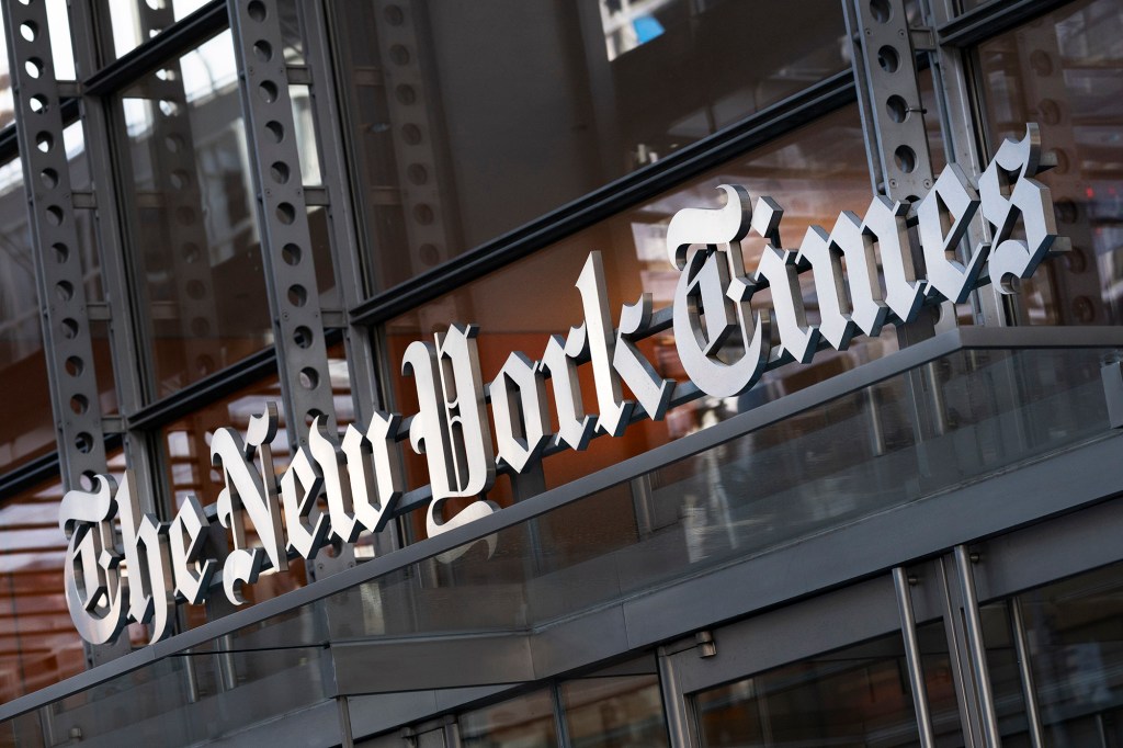 A sign for The New York Times hangs above the entrance to its building, Thursday, May 6, 2021 in New York. 