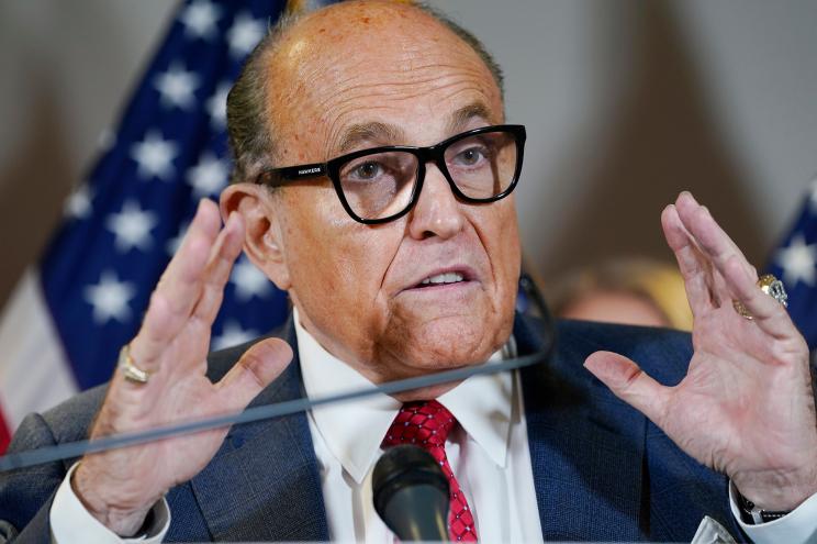 New York Mayor Rudy Giuliani speaks during a news conference at the Republican National Committee headquarters in Washington. Federal agents raided Giuliani’s Manhattan home and office on Wednesday.